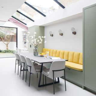 dining room with yellow couch and dining table