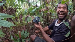 Man smiling after looking at trail cam footage.