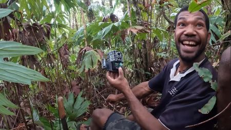 Man smiling after looking at trail cam footage. 