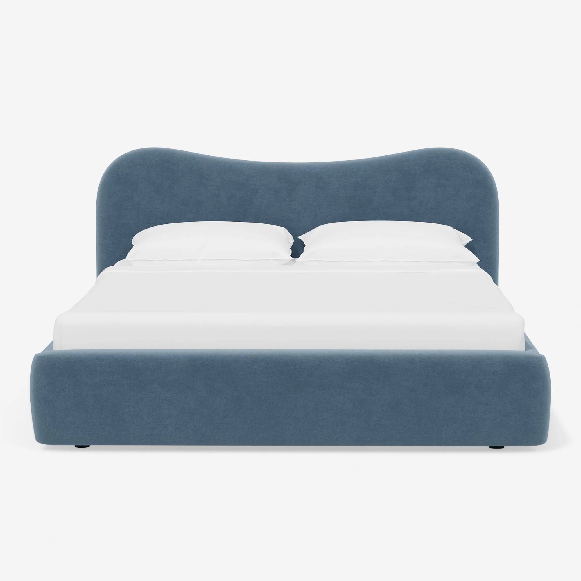 Blue velvet bed with wavy headboard
