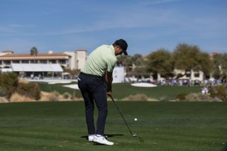 Jordan Spieth strikes a tee shot with an iron