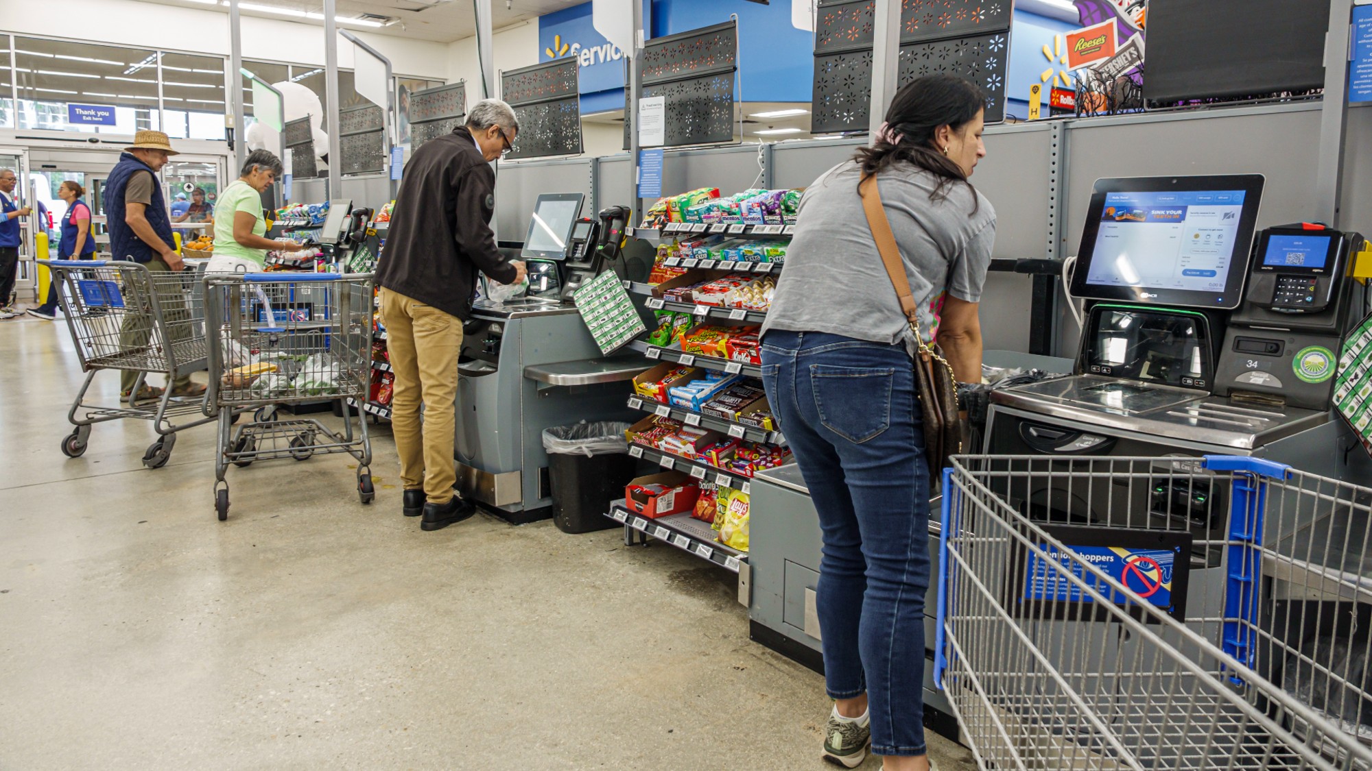 Shoppers in the self-checkout area at a Walmart in Miami, Florida. 