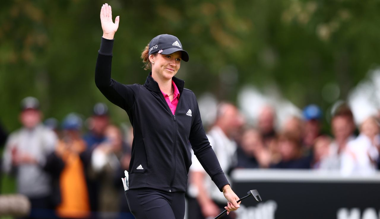 Linn Grant waves to the flag after her victory