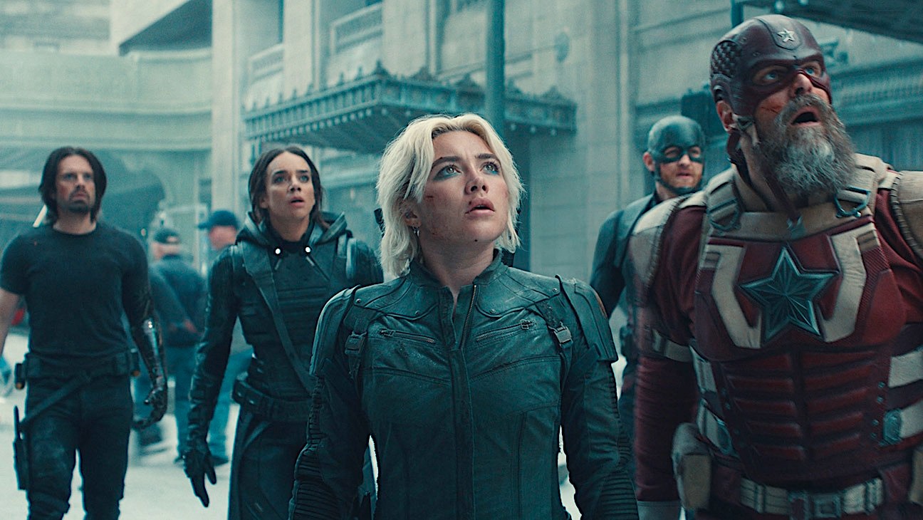 Five superheroes assemble downtown and look up into the sky