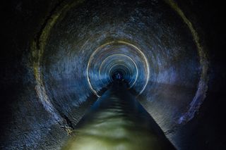 A dark sewer tunnel