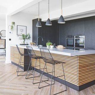 kitchen island with black metal bar chairs