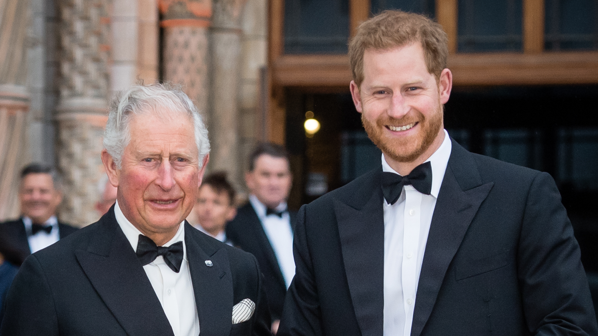 Prince Harry and King Charles wearing tuxedos standing next to each other