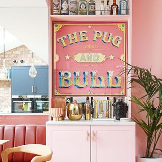 pink home bar with mirror sign