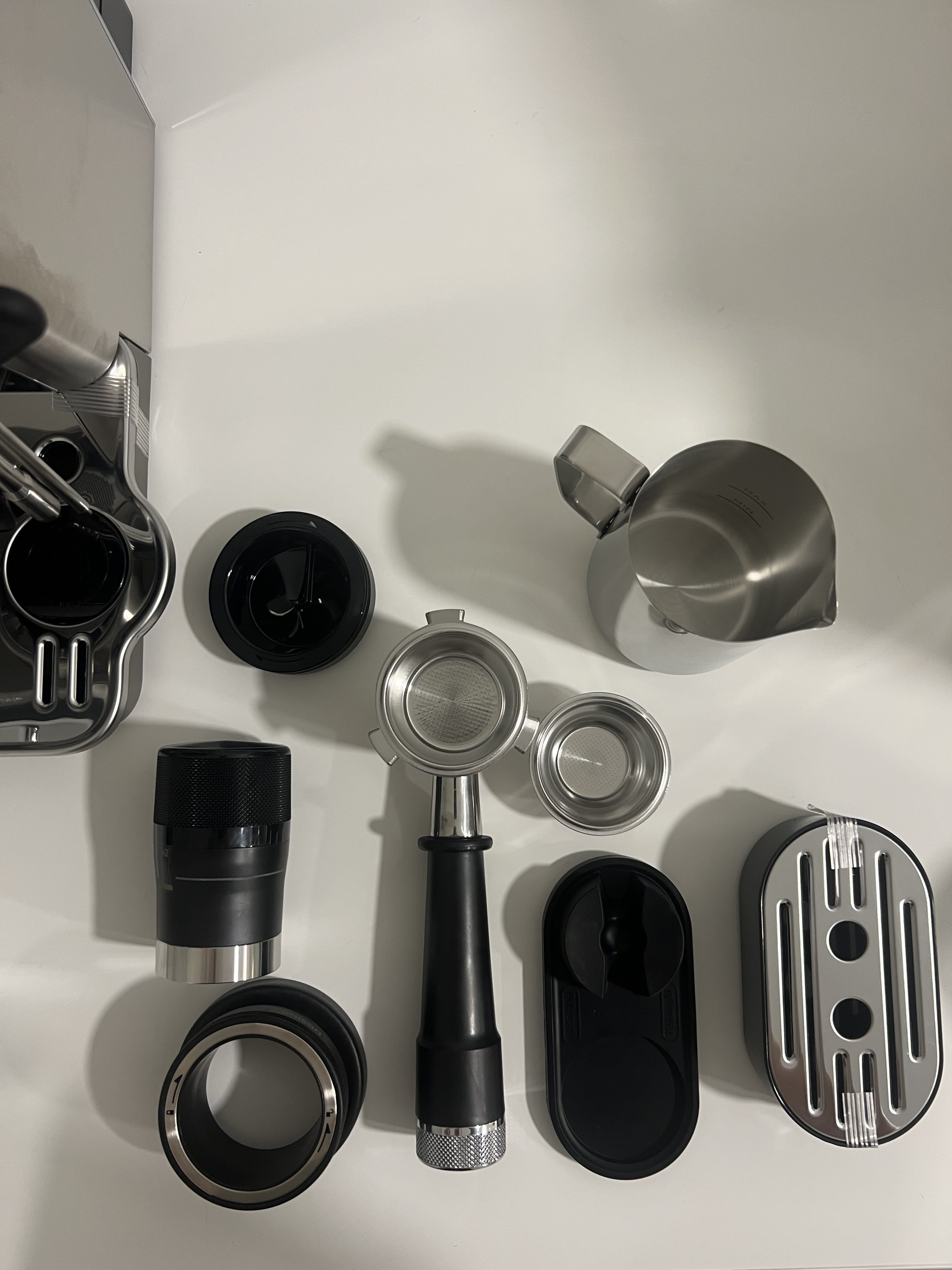 Image of a collection of coffee machine accessories on a white countertop