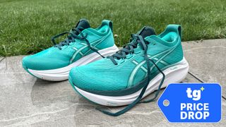 Pictured Asics Gel-Nimbus 27 trainers in blue-green outside with a TG Price Drop badge bottom right
