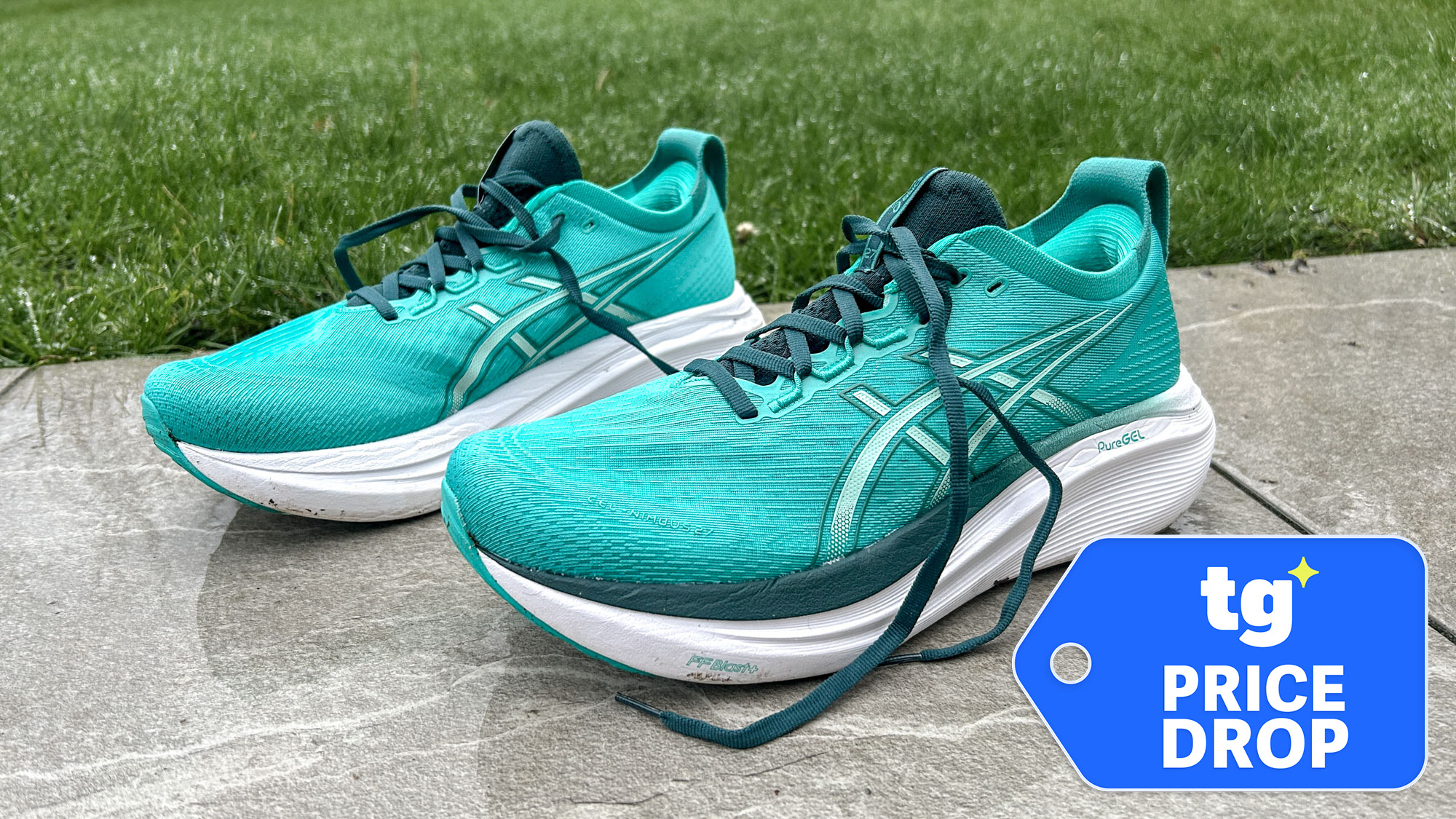 Pictured Asics Gel-Nimbus 27 trainers in blue-green outside with a TG Price Drop badge bottom right
