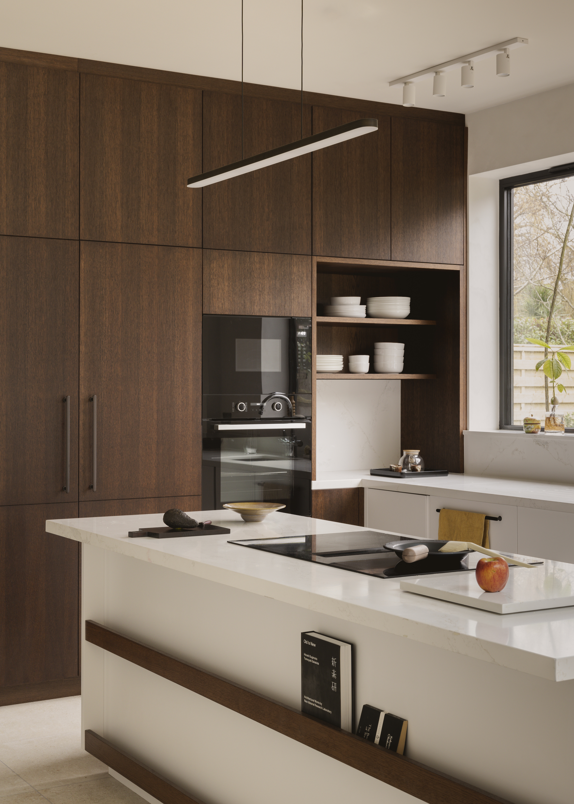 a wood and white kitchen with modern sleek doors and neutral decor