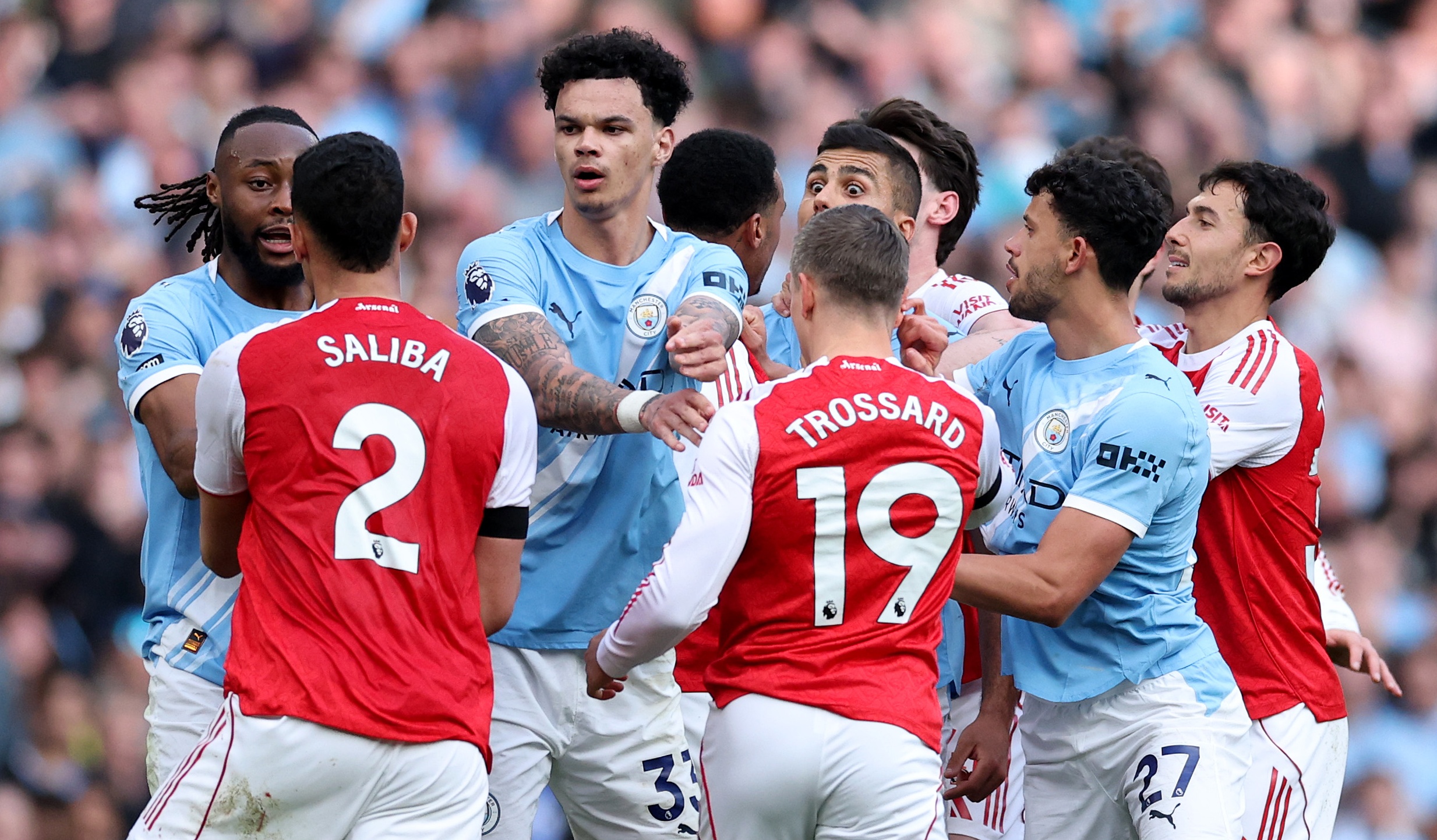 Players of Arsenal and Manchester City clash during the Premier League match between Manchester City and Arsenal at Etihad Stadium on April 19, 2026 in Manchester, England