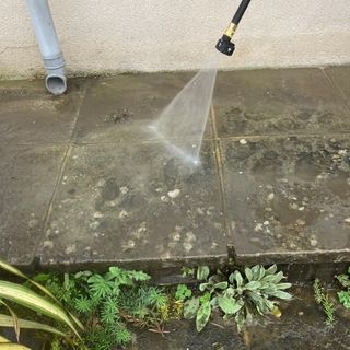 Worx pressure washer being tested on stone patio