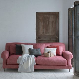 room with pink sofa and white wall