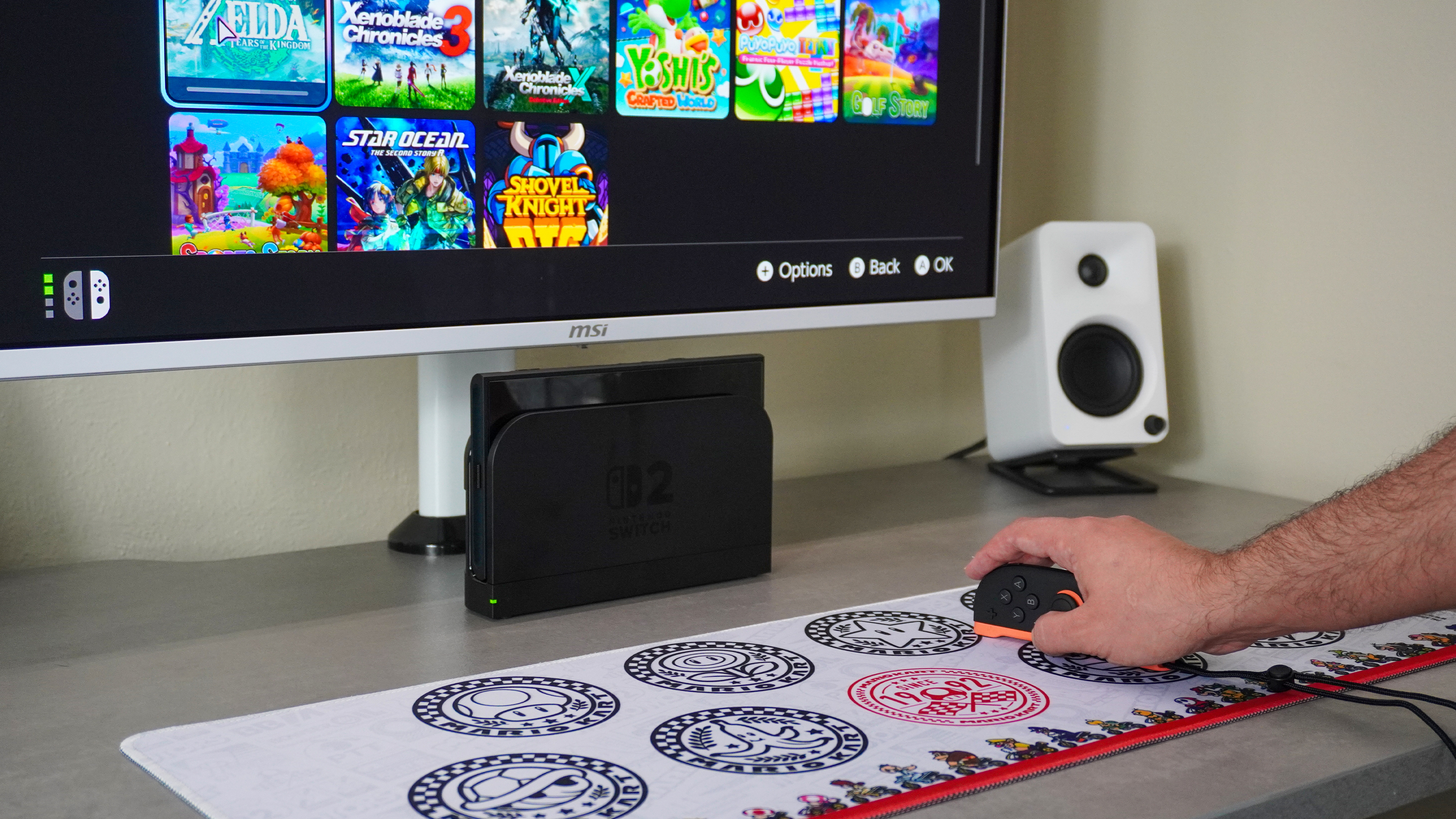 A close-up shot of using Mouse Mode on the Nintendo Switch 2 with the console docked and connected to a monitor