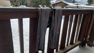 A pair of the Columbia Omni-Heat Midweight Baselayer Tights hanging up on a balcony