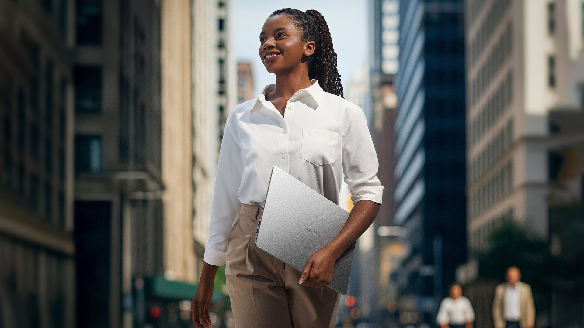 A woman carrying an LG gram laptop