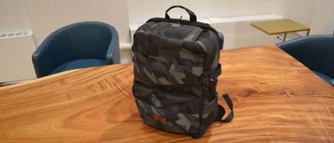 A Hex Technical backpack on a polished woodgrain table