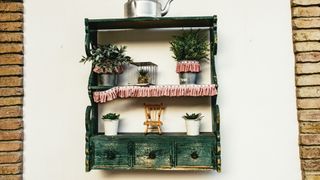 An old dresser has been attached to the wall as a shelf