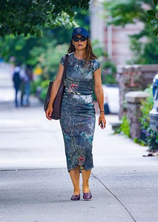 Katie Holmes walks around the Upper West Side wearing a tropical matching set and a Gap baseball cap