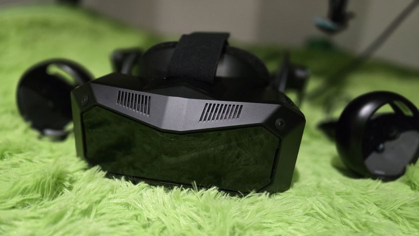 A Pimax Crystal Super virtual reality headset on a green background.