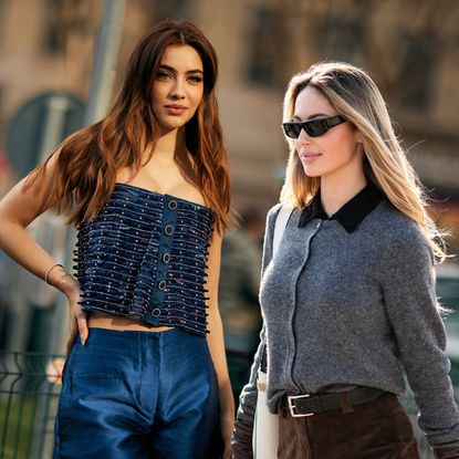 two women in fashionable outfits on the streets of milan with shiny hair