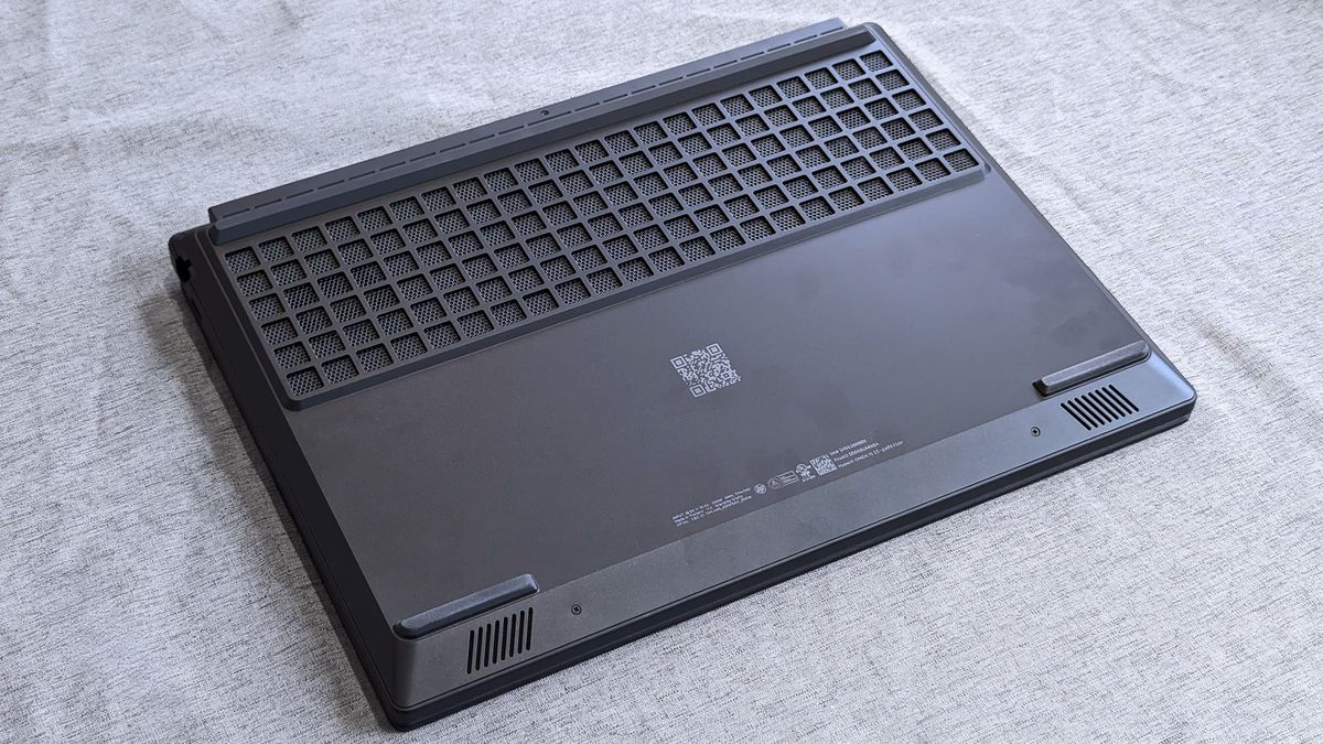 The underside of a HyperX OMEN 15 laptop showing a large rectangular ventilation grille, smaller corner vents, rubber feet, regulatory markings, and a centered QR code.