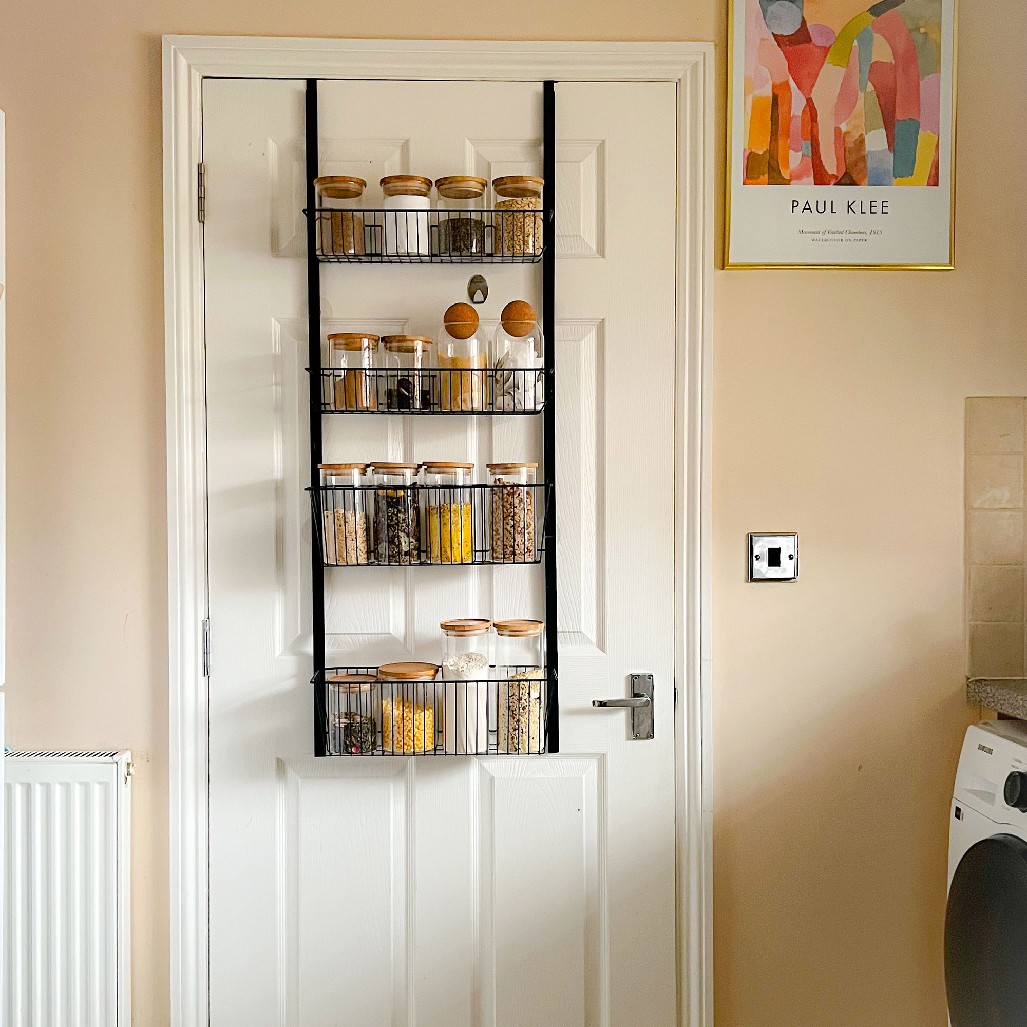 door with hanging shelving on the back of it, holidng jars and ingredients