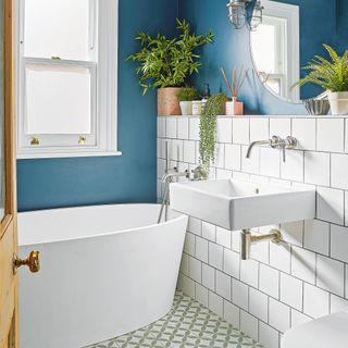 bathroom with white wall brown door