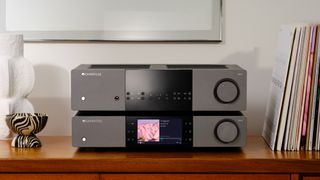 Cambridge Audio EXN100 and Cambridge Audio EXA100 on shelf with vinyl