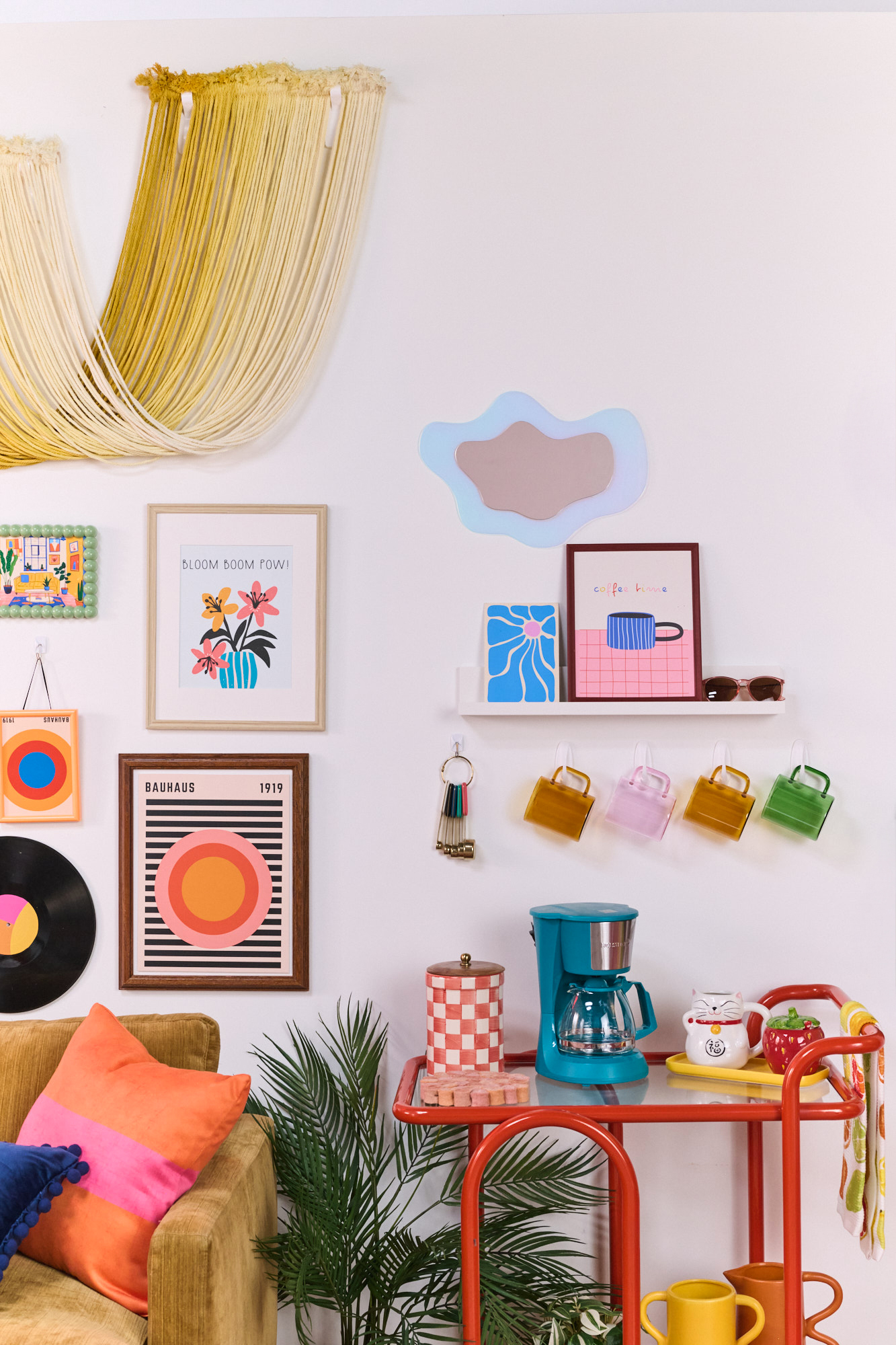 Dorm room kitchen cart area styled with colorful wall art and decals