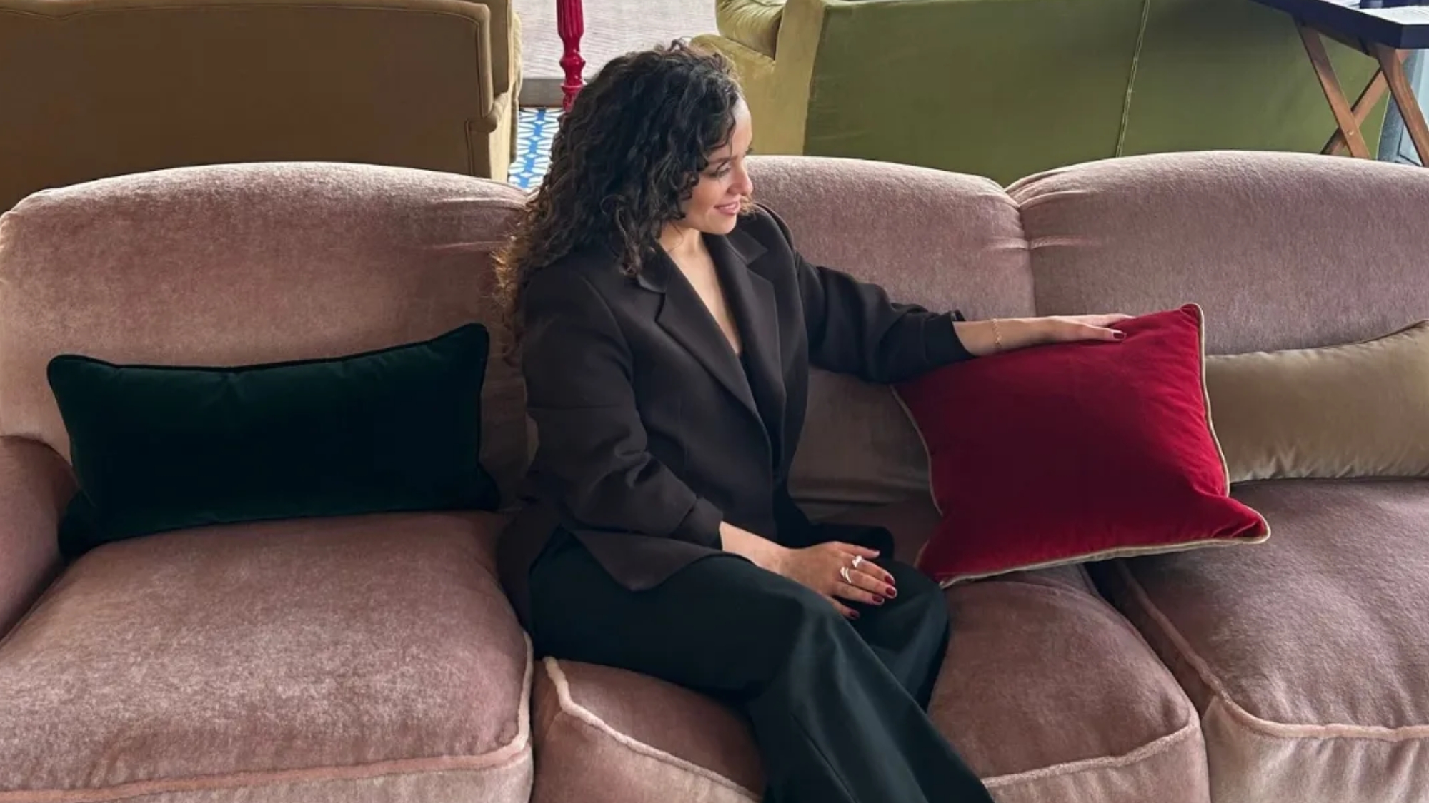 miaad latoof sat on a pink sofa