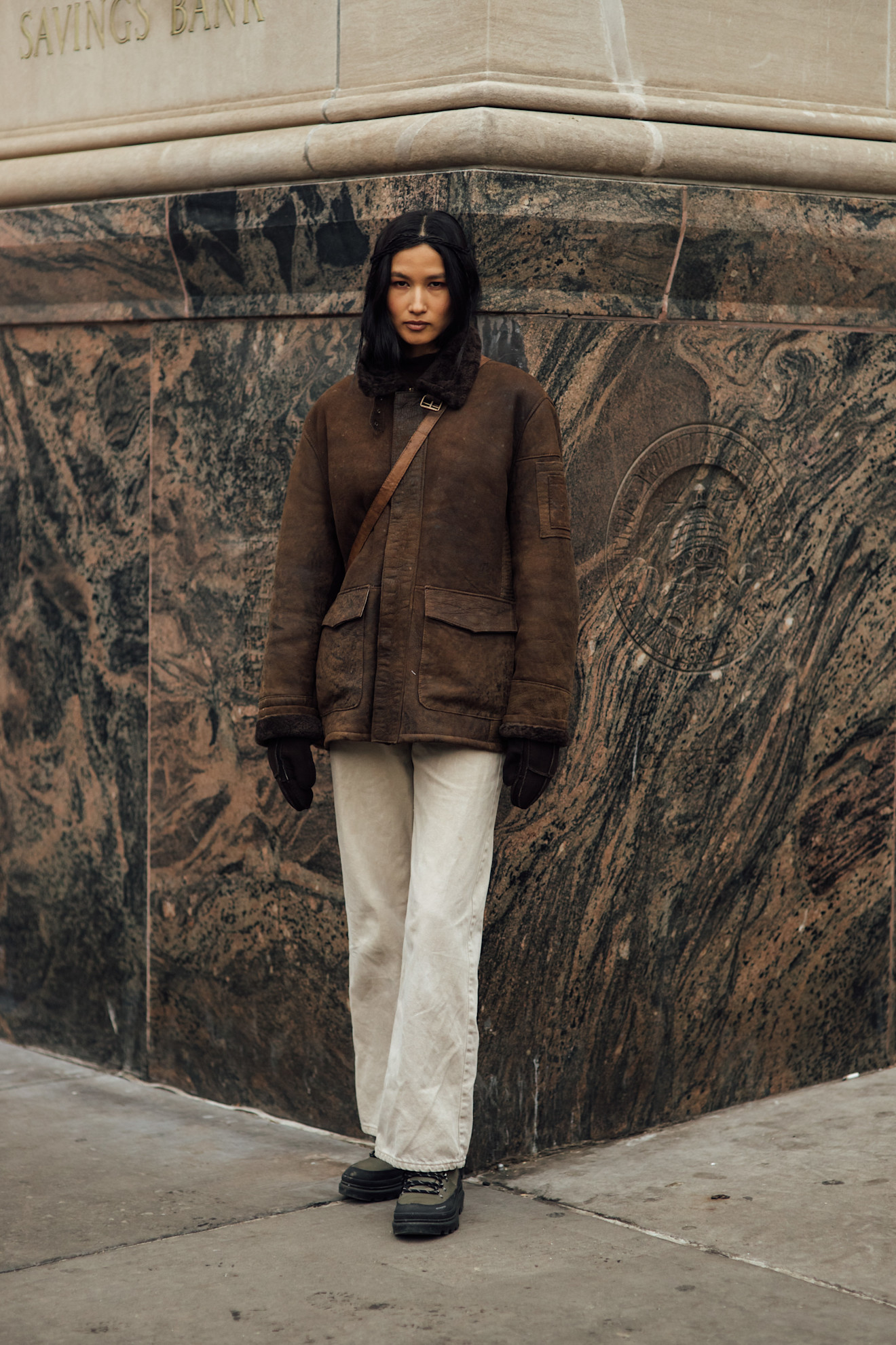 woman wearing brown coat and white pants