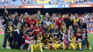 Atletico Madrid players and staff celebrate after winning La Liga following a 1-1 draw against Barcelona at Camp Nou in 2014.