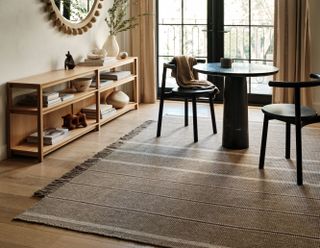 light brown rug in a neutral dining room