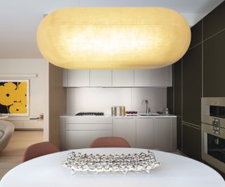 kitchen with bulbous light fixture above dining space at new york apartment