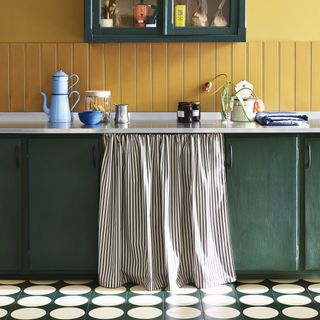 Green kitchen with bright yellow wall