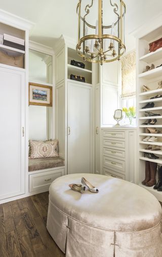 Dress room with oval seating and cream color scheme