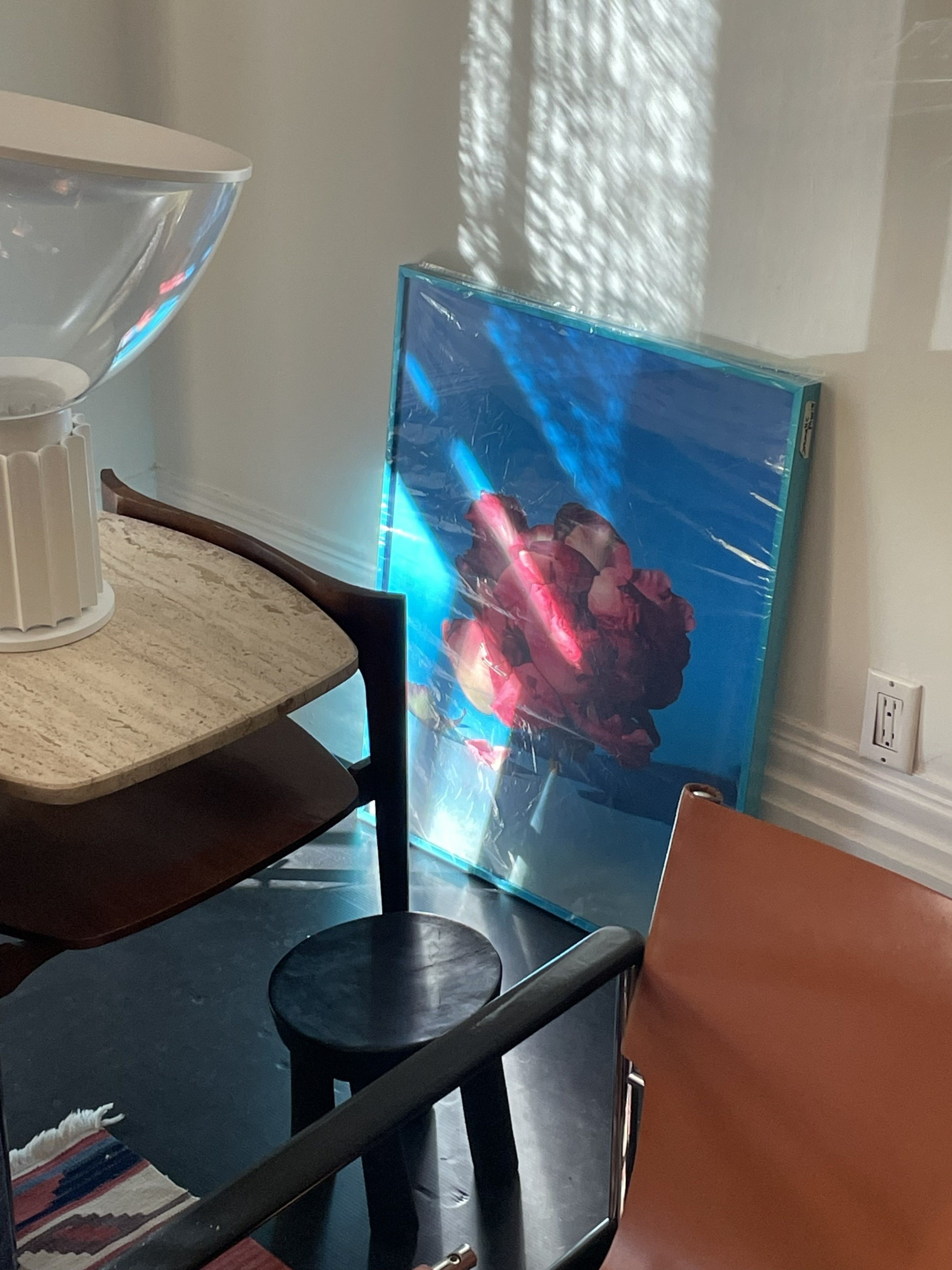 A series of interior shots of an art and objects-filled, dimly lit apartment, a museum's gallery rooms, an empty dance rehearsal room, and colorfully decorated office spaces.