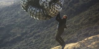 Mission: Impossible Fallout Ethan hanging from a cargo net in mid air