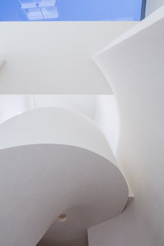 rounded white staircase with skylight