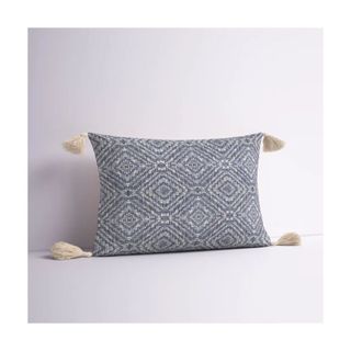 throw pillow with blue pattern and tassels