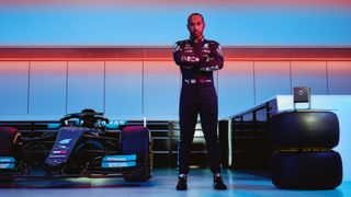Lewis Hamilton posed next to his racing car, with INEOS Hand Sanitizer dispenser