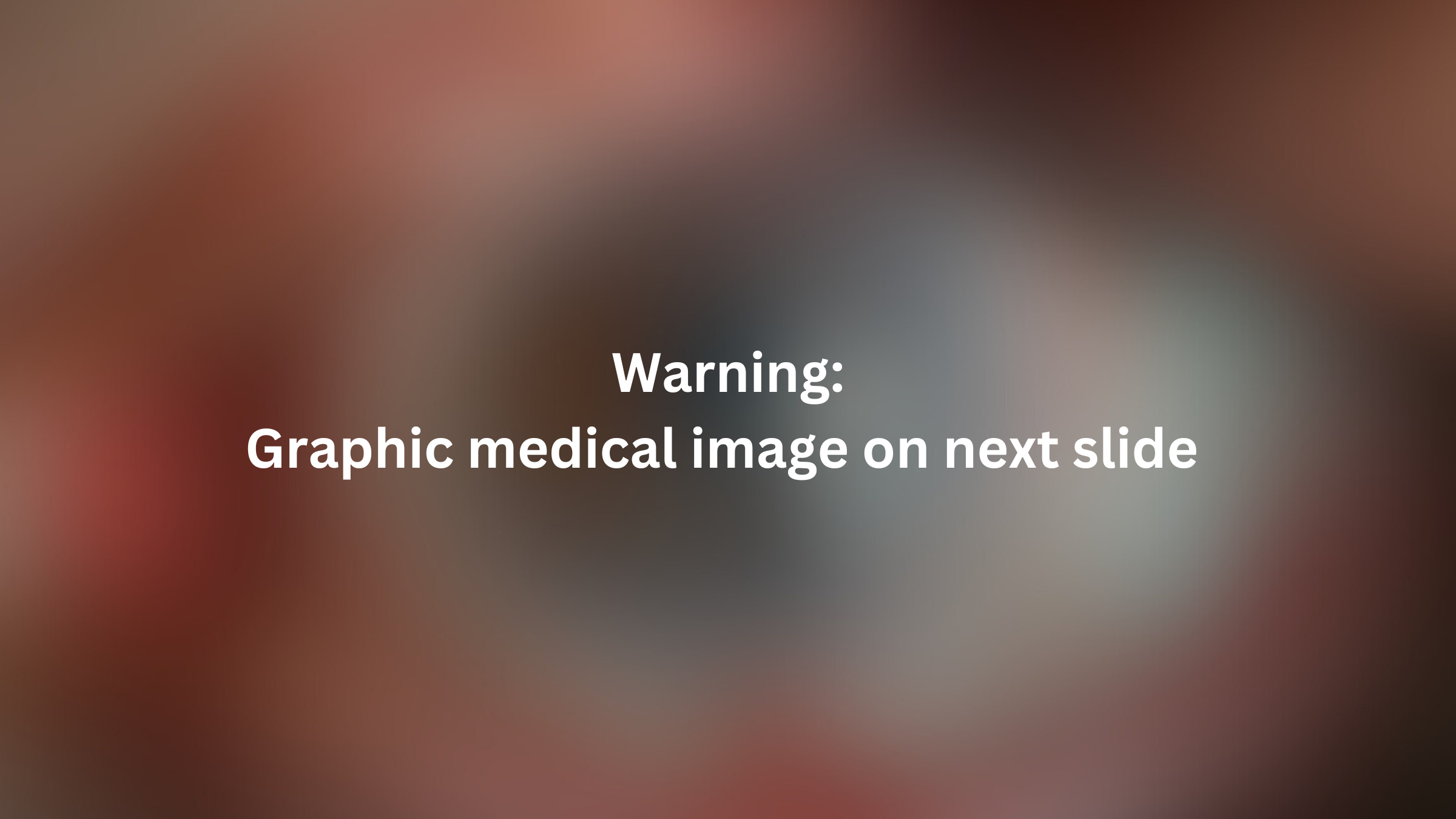 White text is written across a blurred image of the patients' eye. The text reads "Warning: Graphic medical image on next slide"