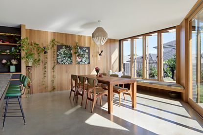 a dining room with concrete flooring
