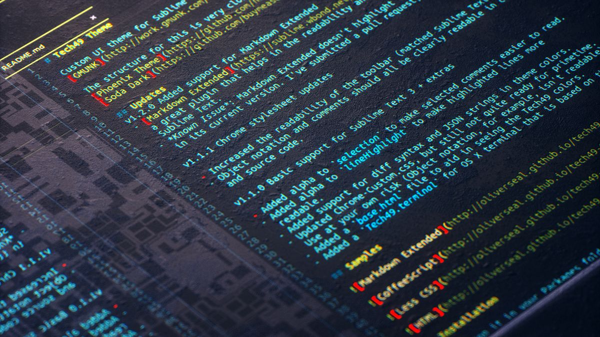 Photo of code, software, person at computer