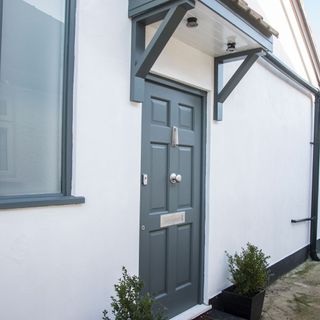 house exterior with grey door and white walls