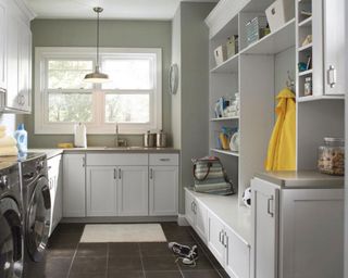 laundry room cabinets in painted white maple in a laundry room with boot room, washing machine, laundry sink, laundry accessories - astrokraft