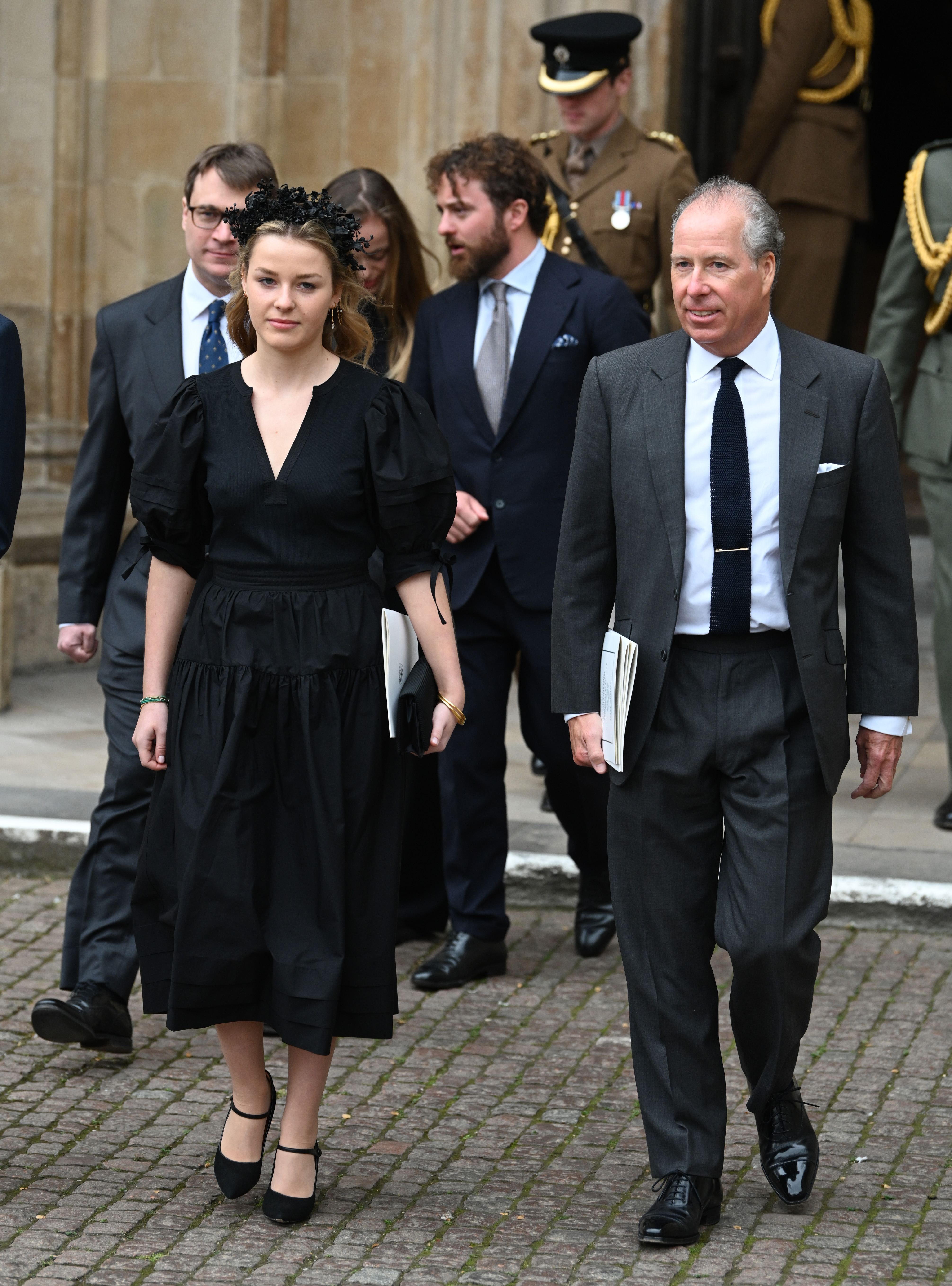 Margarita Armstrong-Jones wearing a black dress walking next to David Armstrong-Jones